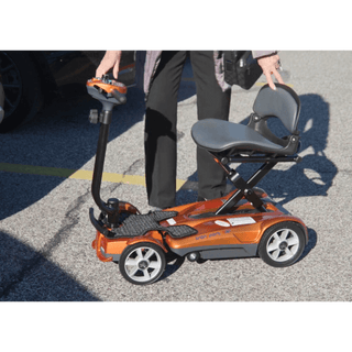 An Elder Ready to Ride a Jupiter Gold Auto Fold Transport 4AF Mobility Scooter
